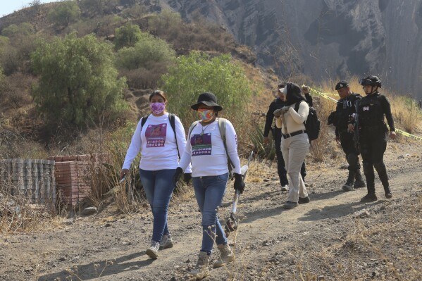 Women carry digging tools at the site where their search team said they found a clandestine crematorium in Tlahuac, on the edge of Mexico City, Wednesday, May 1, 2024. At left is Jacqueline Palmeros who has been searching for her disappeared daughter since 2020 in Mexico City, and at right is María de Jesús Soria whose daughter disappeared in Veracruz in 2016, and whose remains were turned over to her in 2022. (Ǻ Photo/Ginnette Riquelme)