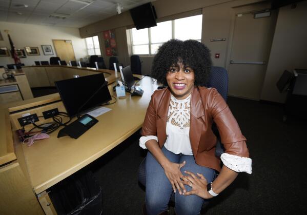 Alexis Knox-Miller, equity director for the Colorado Springs, Colo., school system, poses on Friday, Feb. 4, 2022 in the boardroom in the district's main office in Colorado Springs, Colo. (AP Photo/David Zalubowski)