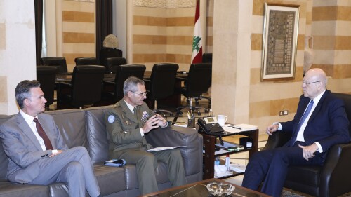 In this photo released by Lebanon's official government photographer Dalati Nohra, Lebanese caretaker Prime Minister Najib Mikati, right, meets with the Head of Mission and Force Commander of the United Nations Interim Force in Lebanon (UNIFIL), Major General Aroldo Lazaro Saenz of Spain, center, in Beirut, Lebanon, Monday, July 10, 2023. The commander of the U.N. peacekeeping force deployed on the tense Lebanon-Israel border relayed Monday an Israeli request to remove a tent set up by the militant Hezbollah group in a disputed area along the frontier, the foreign minister said Monday. (Dalati Nohra via AP)