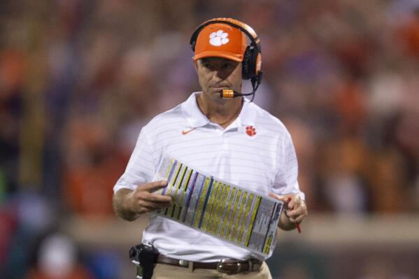 Clemson head coach Dabo Swinney looks at his play card during the first half of an NCAA college football game against Boston College Saturday, Oct. 2, 2021, in Clemson, S.C. (AP Photo/Hakim Wright Sr.)