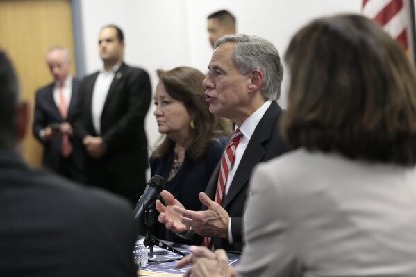 Texas Governor Greg Abbott sits with families of victims and survivors of the Aug. 3 shooting at Walmart in El Paso, Texas, Thursday, Aug. 29, 2019. About 30 representatives from law enforcement and non governmental agencies were on the roundtable discussion of public safety. (Mark Lambie/The El Paso Times via AP)