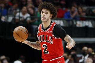 FILE - Chicago Bulls guard Lonzo Ball (2) dribbles up court against the Dallas Mavericks in the first half of an NBA basketball game in Dallas, Sunday, Jan. 9, 2022. Chicago Bulls point guard Lonzo Ball will have a cartilage transplant in his left knee, the team and his agency Klutch Sports said Thursday, March 16, 2023. (AP Photo/Tim Heitman, File)