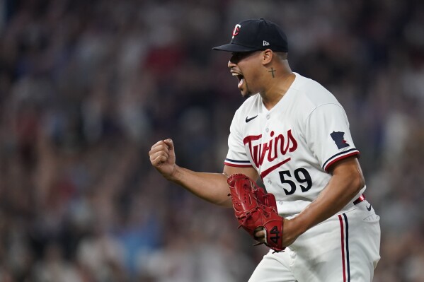 Minnesota Twins relief pitcher Jhoan Duran celebrates after forcing the final out to defeat the Los Angeles Angels in a baseball game Friday, Sept. 22, 2023, in Minneapolis. (AP Photo/Abbie Parr)