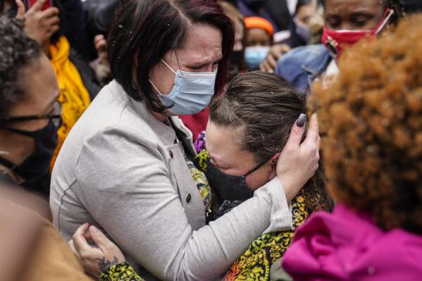 Courtney Ross, girlfriend of the deceased George Floyd, left, hugs Katie Wright, mother of the deceased Daunte Wright, right, before a news conference, Tuesday, April 13, 2021, in Minneapolis. Daunte Wright, 20, was shot and killed by police Sunday after a traffic stop in Brooklyn Center, Minn. (AP Photo/John Minchillo)