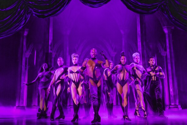 This image released by Polk & Co. shows Taurean Everett, center, with the cast during a performance of "Death Becomes Her" in New York. (Matthew Murphy and Evan Zimmerman/Polk & Co. via AP)