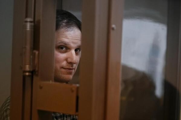 FILE - Wall Street Journal reporter Evan Gershkovich stands in a glass cage in a courtroom at the Moscow City Court, in Moscow, Russia, on April 18, 2023. Gershkovich, a 31-year-old U.S. citizen, was arrested in March while on a reporting trip in Russia. He, his employer and the U.S. government have denied the charges. A Moscow court on Tuesday extended his detention until Aug. 30, and the journalist has appealed the ruling. (AP Photo/Alexander Zemlianichenko, File)