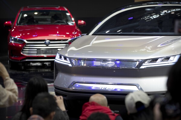 FILE - Attendees take photos of the E-SEED electric concept car during a press conference by Chinese automaker BYD at the China Auto Show in Beijing, on April 25, 2018. China's Commerce Ministry has protested a decision by the European Union to investigate exports of Chinese electric vehicles, saying Thursday, Sept. 14, 2023 that it is a “protectionist” act aimed at distorting the supply chain. (AP Photo/Mark Schiefelbein, File)