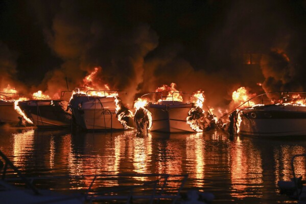 Boats are on fire in Medulin, Croatia, early Wednesday, May 15, 2024. A fire early on Wednesday at a marina in northwestern Croatia destroyed 22 boats and caused huge damage but no injuries. (AP Photo/Goran Sebelic, Cropix)