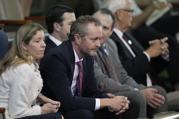 Whistleblower Blake Brickman, former deputy attorney general, second from left, attends the closing arguments in the impeachment trial for suspended Texas Attorney General Ken Paxton in the Senate Chamber at the Texas Capitol, Friday, Sept. 15, 2023, in Austin, Texas. (AP Photo/Eric Gay)