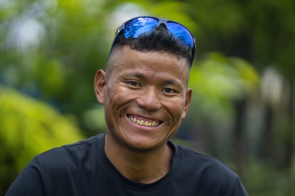 Nepal's sherpa guide Tenjen Sherpa, 35, who with Norwegian climber Kristin Harila climbed the world's 14 tallest mountains in record time, poses during an interview with the Associated Press in Kathmandu, Nepal, Wednesday, Aug. 9, 2023. Sherpa and Harila shattered the record for the fastest climb of the 14 mountains more than 8,000 meters (about 26,000 feet) high when they topped Mount K2 in Pakistan late last month. The previous record was 189 days, and the pair did it in 92 days. (AP Photo/Niranjan Shrestha)