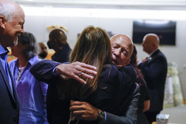 Karen Harris, center, daughter of victim Miriam Nelson, embraces district attorney John Creuzot as her husband Cliff Harris, left, reacts, after Billy Chemirmir was found guilty during the final day of his third court trial at Frank Crowley Courts Building in Dallas on Friday, Oct. 7, 2022. Chemirmir, 49, is charged with capital murder of 22 elderly people in North Texas. (Shafkat Anowar/The Dallas Morning News via AP)