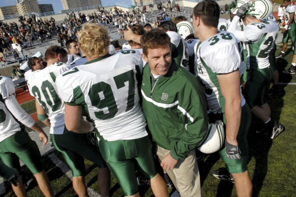 FILE - Dartmouth coach Buddy Teevens celebrates with the team after a win over Columbia during college football game Oct. 21, 2006, in New York. Teevens, the innovative Ivy League football coach who brought robotic tackling dummies to Dartmouth practices, died Tuesday, Sept. 19, 2023, of injuries he sustained from a bicycle accident in March. He was 66. School president Sian Leah Beilock and athletic director Mike Harrity announced Teevens' death in a letter to the Dartmouth community. (AP Photo/Paul Hawthorne, File)