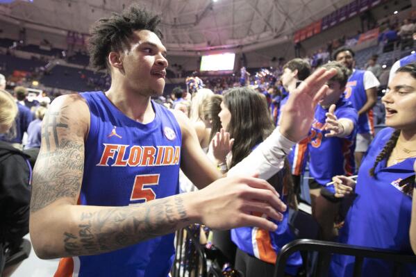 Florida guard Will Richard celebrates with fans after the second half of an NCAA college basketball game Wednesday, Feb. 1, 2023, in Gainesville, Fla. (AP Photo/Alan Youngblood)