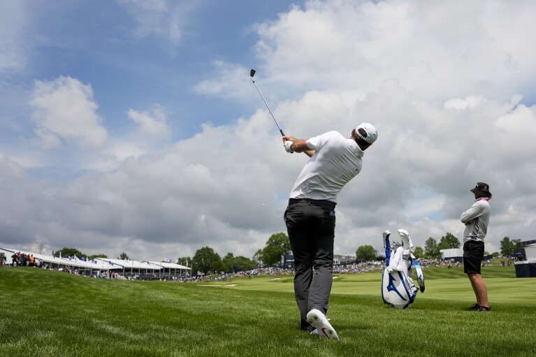 Scottie Scheffler hits from the rough on the 18th hole during a practice round for the PGA Championship golf tournament at the Valhalla Golf Club, Wednesday, May 15, 2024, in Louisville, Ky. (AP Photo/Matt York)