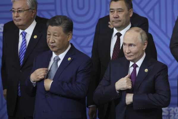 Chinese President Xi Jinping, left, and Russian President Vladimir Putin attend a group photo ceremony prior to Outreach/BRICS Plus format session at the BRICS Summit in Kazan, Russia, Oct. 24, 2024. (Maxim Shipenkov, Pool Photo via AP, File)