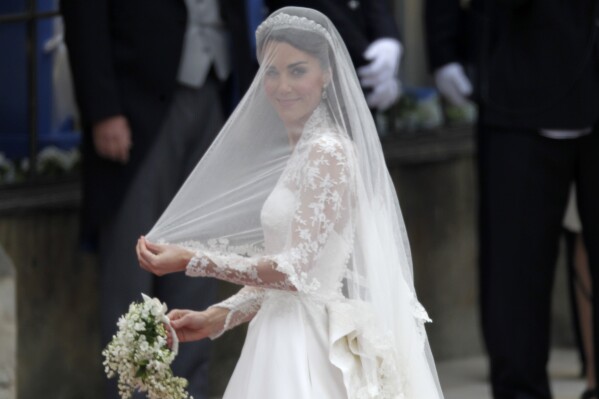 FILE - Kate Middleton arrives for her wedding with Britain's Prince William at Westminster Abbey at the Royal Wedding in London Friday, April 29, 2011. Attention on Princess Kate has reached levels not seen since she married Prince William in a fairy-tale wedding in 2011. An admission from Kate that she altered an official family photo triggered a backlash. (AP Photo/Gero Breloer, File)