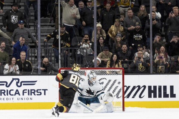 Vegas Golden Knights right wing Jonathan Marchessault (81) scores a goal on San Jose Sharks goaltender Kaapo Kahkonen (36) during a shootout of an NHL hockey game Sunday, Dec. 10, 2023, in Las Vegas. (AP Photo/Ellen Schmidt)