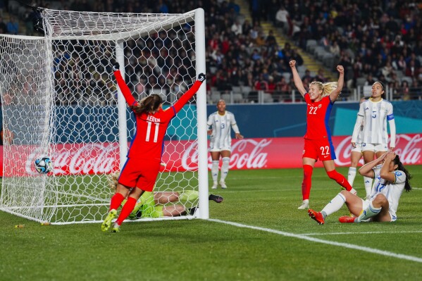 Norway players celebrate after Philippines' Alicia Barker, bottom right, scored an own goal during the Women's World Cup Group A soccer match between Norway and Philippines at Eden Park stadium in Auckland, New Zealand, Sunday, July 30, 2023. Norway defeated Philippines 6-0. (AP Photo/Abbie Parr)