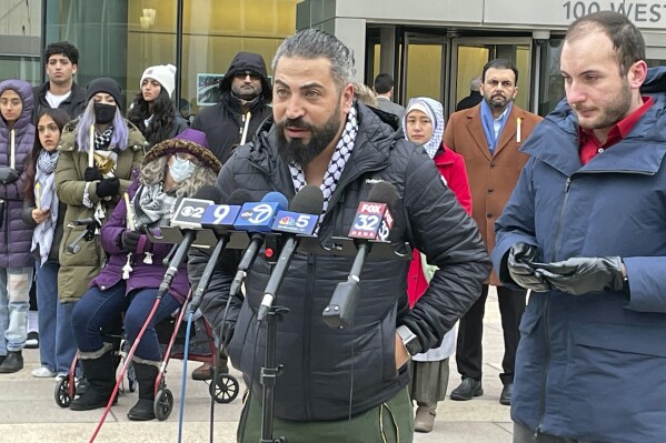 Odai Alfayoumi, father of slain 6-year-old Wadi Alfayoumi, addresses reporters in front of the Will County Courthouse in Joliet, Illinois, Wednesday, Jan. 3, 2024.  Alfayoumi attended a vigil outside the courthouse to remember her son before the pretrial.  Hearing for Joseph Czuba, who is accused of murdering the child and injuring his mother and targeting the family for its Muslim faith.  (AP Photo/Claire Savage)