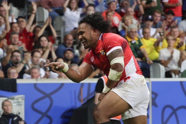 Tonga's Solomone Kata celebrates after scoring a try during the Rugby World Cup Pool B match between Tonga and Romania at the Stade Pierre Mauroy in Villeneuve-d'Ascq, outside Lille, France, Saturday, Oct. 8, 2023. (AP Photo/Michel Spingler)