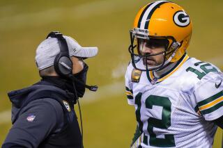 FILE - In this Jan. 3, 2021, file photo, Green Bay Packers head coach Matt LaFleur, left, talks to Aaron Rodgers during the second half of an NFL football game against the Chicago Bears in Chicago. LaFleur reiterated his hope that he’d get to continue working with Rodgers this season while offering no news on the quarterback’s status. (AP Photo/Charles Rex Arbogast, File)