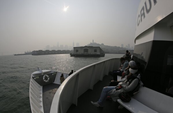
              The skyline is obscured by smoke and haze from wildfires as a ferryboat returns to the waterfront Thursday, Nov. 15, 2018, in San Francisco. Recurring wildfires are sparking concern among medical experts about potentially major health consequences. Worsening asthma, lung disease and even heart attacks in heart disease patients have all been linked with previous fires. But blazes that used to be seasonal are happening nearly year-round and increasingly spreading into cities. That's exposing many more people to choking smoke that contains many of the same toxic ingredients as urban air pollution. (AP Photo/Eric Risberg)
            