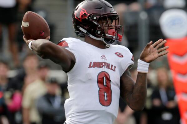 FILE - In this Oct. 28, 2017, file photo, Louisville's Lamar Jackson (8) looks to pass against Wake Forest during the second half of an NCAA college football game in Winston-Salem, N.C.   Louisville will retire the No. 8 jersey number of former Cardinals quarterback Lamar Jackson, who in 2016 became the school’s first Heisman Trophy winner and finished his college football career as one of its most decorated players. Jackson’s jersey number will be retired during a ceremony at Louisville’s Nov. 13, 2021 home game against Syracuse.(AP Photo/Chuck Burton, File)