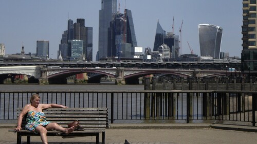 FILE - A woman sunbathes near the River Thames in front of a view of the City of London on June 17, 2022. Britain had its hottest June since records began in 1884 , the country's meteorological agency said on Monday, July 3, 2023. , adding that human-induced climate change means that this unusual heat will be more frequent in the coming decades.  The UK's average June temperature reached 15.8 degrees Celsius (Fahrenheit), 0.9 degrees Celsius higher than the combined previous record of 14.9 degrees Celsius in 1940 and 1976, according to provisional Met Office figures .  (AP Photo/Kirsty Wigglesworth)