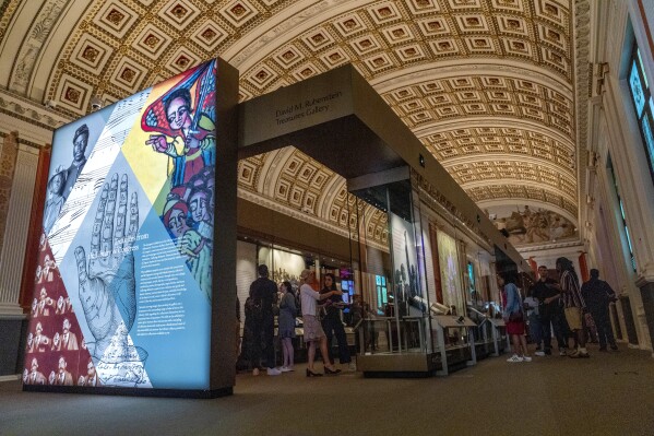 People visit the exhibit, "Collecting Memories: Treasures from the Library of Congress," during a media preview at the Library of Congress, Monday, June 10, 2024, in Washington. (AP Photo/Jacquelyn Martin)