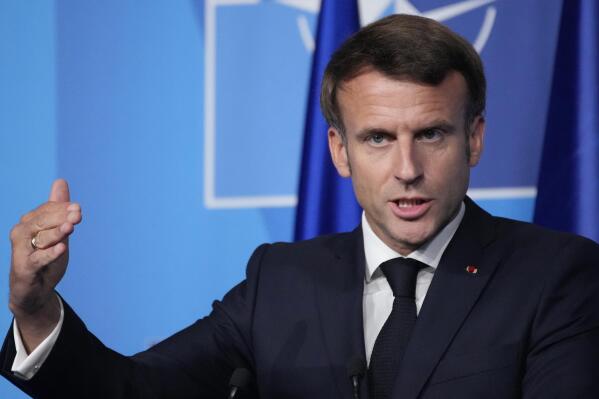 FILE - French President Emmanuel Macron speaks during a press conference after a NATO summit, June 30, 2022 in Madrid. French President Emmanuel Macron arrives in Yaounde, the capital of Cameroon, late Monday July 26, 2022, to begin his three-day tour to this central African nation as well as Benin and Guinea Bissau. (AP Photo/Christophe Ena, File)