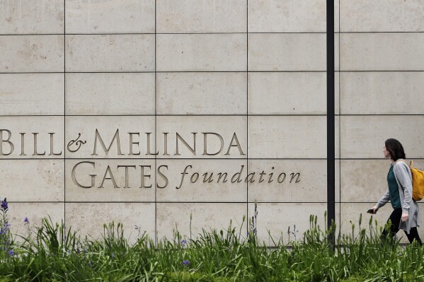 FILE - A person walks by the headquarters of the Bill and Melinda Gates Foundation on April 27, 2018, in Seattle. The Bill & Melinda Gates Foundation threw its weight behind a call to save the lives of women in child birth and their children on Wednesday, Sept. 20, 2023, at its annual Goalkeepers conference on the side lines of the U.N. General Assembly in New York. (AP Photo/Ted S. Warren, File)