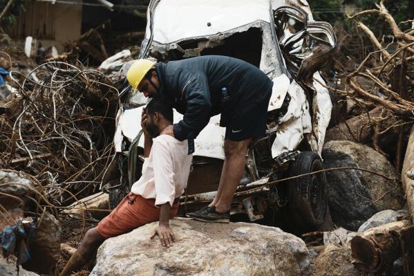 A rescuer consoles a man who lost his home following Tuesday's landslides at Chooralmala, Wayanad district, Kerala state, India, Wednesday, July 31, 2024. (AP Photo/Rafiq Maqbool)