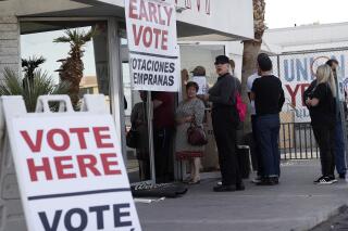 FILE - In this Feb. 15, 2020, file photo, people wait in line at an early voting location at the culinary workers union hall in Las Vegas. A businessman is facing criminal charges of voting twice in the November 2020 election, including voting with his dead wife's ballot. Nevada state Attorney General Aaron Ford announced Thursday, Oct. 21, 2021, that Donald "Kirk" Hartle faces felony charges that could get him up to eight years in prison (AP Photo/John Locher, File)