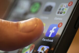 FILE - In this Aug. 11, 2019, file photo, an iPhone displays the Facebook app in New Orleans. Facebook says it’s going all in to block the spread of bogus vaccine claims. In practice, that means the social network plans to ban a new bunch of false claims in addition to the old bunch of false claims about vaccines or COVID-19 that it has already banned. (AP Photo/Jenny Kane, File)