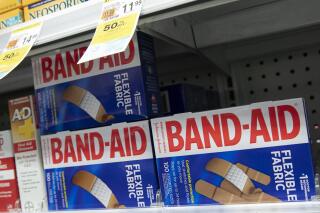 FILE - Band-Aids, from Johnson & Johnson, are displayed in a pharmacy, Thursday, July 16, 2020, in New York. Johnson & Johnson topped third-quarter expectations thanks to growth in pharmaceutical sales, but the health care giant continued to tread cautiously with its outlook due to foreign exchange rates.(AP Photo/Mark Lennihan, File)