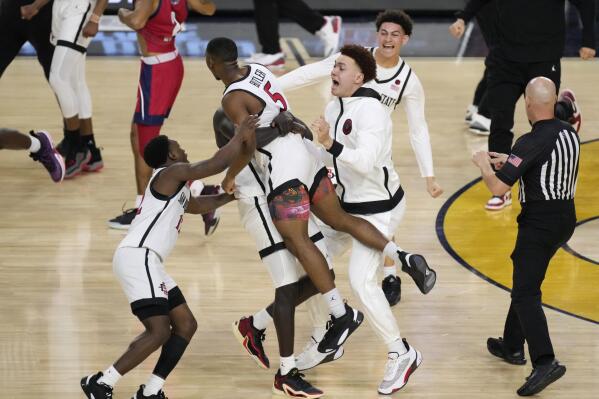 San Diego State guard Lamont Butler (5) celebrates with teammates after hitting the winning basket against Florida Atlantic during the second half of a Final Four college basketball game in the NCAA Tournament on Saturday, April 1, 2023, in Houston. (AP Photo/Godofredo A. Vasquez)