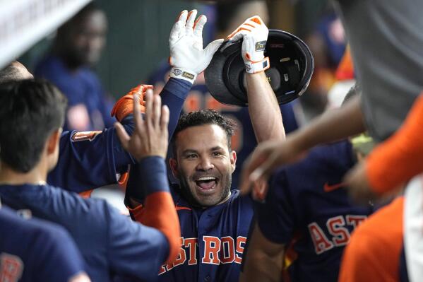 Houston Astros' Jose Altuve celebrates with teammates in the dugout after hitting a home run during the first inning of a baseball game against the Texas Rangers Sunday, May 22, 2022, in Houston. (AP Photo/David J. Phillip)