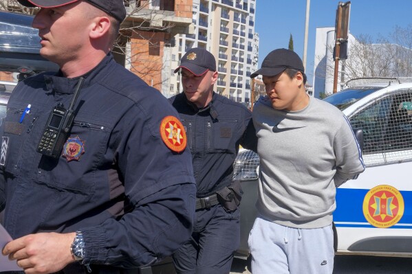 FILE - Montenegrin police officers escort South Korean citizen, Terraform Labs founder Do Kwon in Montenegro's capital Podgorica, March 24, 2023. A court in Montenegro has ruled that Do Kwon should be extradited to the United States to face fraud charges rather than to his native South Korea, a court official in the Balkan Country said Thursday Feb. 22, 2024. Do Kwon, 32, was arrested nearly a year ago in Montenegro on an international arrest warrant in connection with a $40 billion crash of Terraform Labs' cryptocurrency, which devastated retail investors around the world. (AP Photo/Risto Bozovic, File)