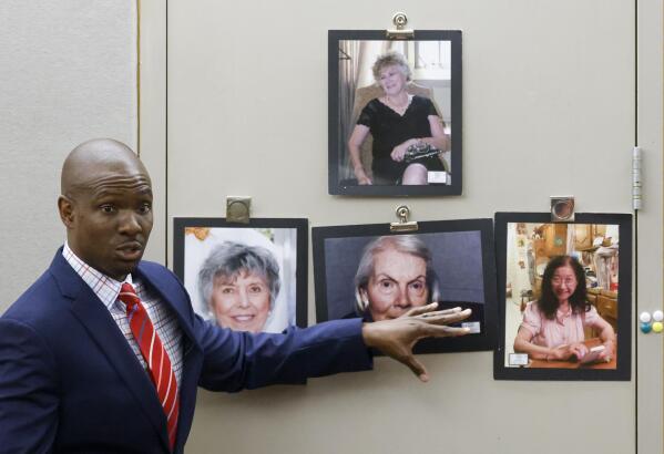 Defense lawyer Kobby Warren points towards the photographs of the victims as delivers his closing statement during the final day of the third trial of Billy Chemirmir at Frank Crowley Courts Building in Dallas on Friday, Oct. 7, 2022. Chemirmir, 49, is charged with capital murder of 22 elderly people in North Texas. (Shafkat Anowar/The Dallas Morning News via AP)