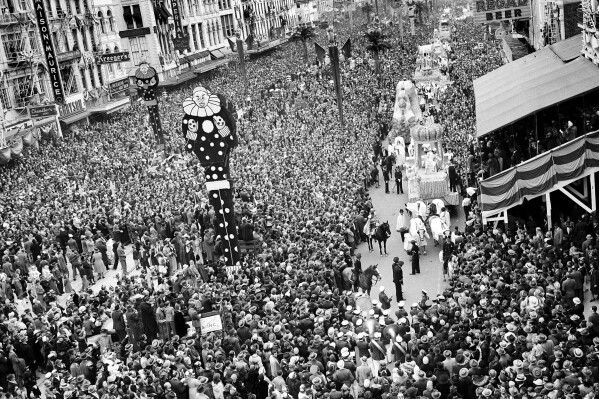 Mardi Gras revelers gather at Canal Street as Rex, King of Carnival, makes his way aboard his float through the crowd Feb. 26, 1941, in New Orleans La. An estimate of half a million people lined the streets for the festivities. (AP Photo,file)
