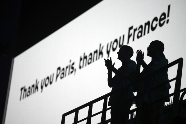Spectators applaud during the 2024 Summer Olympics closing ceremony at the Stade de France, Sunday, Aug. 11, 2024, in Saint-Denis, France. (AP Photo/Kin Cheung)