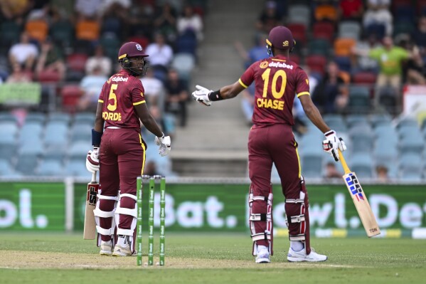 Matthew Forde, left, of the West Indies argues with teammate Roston Chase during the third one day international between Australia and the West Indies at the Manuka Oval in Canberra, Australia, Tuesday, Feb. 6, 2024. (Lukas Coch/AAP Image via AP)