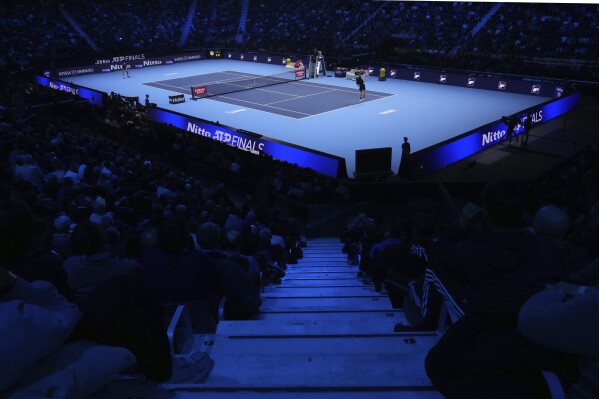 United States' Taylor Fritz, right, serves the ball to Australia's Alex de Minaur during their singles tennis match of the ATP World Tour Finals at the Inalpi Arena, in Turin, Italy, Thursday, Nov. 14, 2024. (AP Photo/Antonio Calanni)