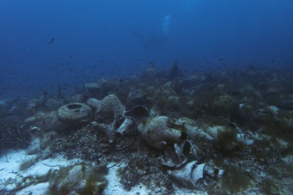 
              In this photo taken on Sunday, April 7, 2019, ancient amphoras lie at the bottom of the sea from a 5th Century B.C. shipwreck, the first ancient shipwreck to be opened to the public in Greece, including to recreational divers who will be able to visit the wreck itself, near the coast of Peristera, Greece. Greece’s rich underwater heritage has long been hidden from view, off-limits to all but a select few, mainly archaeologists. Scuba diving was banned throughout the country except in a few specific locations until 2005, for fear that divers might loot the countless antiquities that still lie scattered on the country’s seabed. Now that seems to be gradually changing, with a new project to create underwater museums. (AP Photo/Elena Becatoros)
            