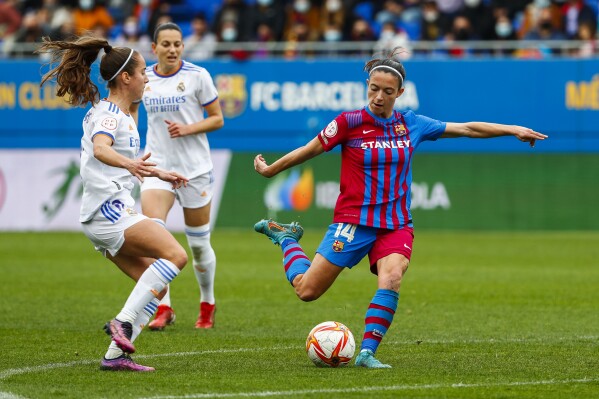 FILE - Barcelona's Aitana Bonamati, right, shoots the ball next to Real Madrid's Maite Oroz during the Women's Spanish La Liga soccer match between FC Barcelona and Real Madrid in Barcelona, Spain, Sunday, March 13, 2022. The players for Spain's women's league maintain they'll go on strike rather than start the new season after salary negotiations with the league broke down on Thursday, Sept. 7, 2024. (AP Photo/Joan Monfort, File)
