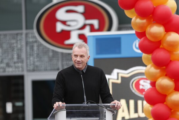 FILE - In this Oct. 21, 2018, file photo, Former San Francisco 49ers quarterback Joe Montana speaks at a ceremony commemorating "The Catch" to unveil a statues of himself and wide receiver Dwight Clark before an NFL football game between the 49ers and the Los Angeles Rams in Santa Clara, Calif. Hall of Fame quarterback Joe Montana and his wife confronted a home intruder who attempted to kidnap their grandchild over the weekend, law enforcement confirmed on Sunday, Sept. 27, 2020.  (AP Photo/Tony Avelar, File)
