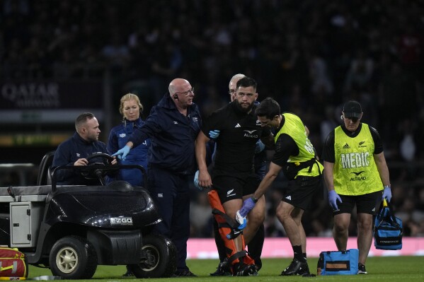 New Zealand's Tyrel Lomax, centre, is being assisted by the medical team during the rugby union international match between South Africa and New Zealand, at Twickenham stadium in London, Friday, Aug. 25, 2023. (AP Photo/Alastair Grant)