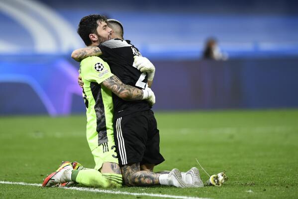 Sheriff's goalkeeper Giorgos Athanasiadis, left, and Sheriff's Dimitris Kolovos celebrate at the end of the Champions League group D soccer match between Real Madrid and Sheriff, Tiraspol at the Bernabeu stadium in Madrid, Spain, Tuesday, Sept. 28, 2021. (AP Photo/Jose Breton)