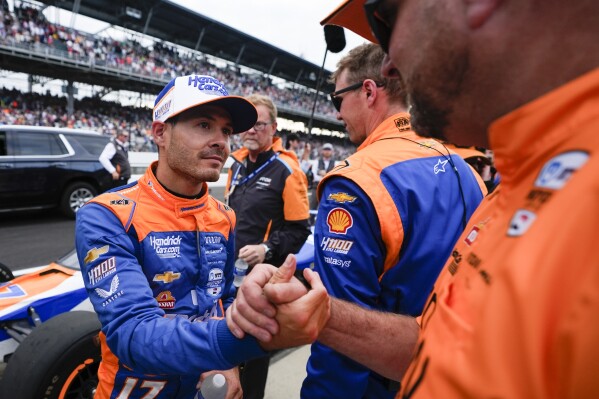 Kyle Larson, left, shakes hands with a crew member after the Indianapolis 500 auto race at Indianapolis Motor Speedway, Sunday, May 26, 2024, in Indianapolis. (AP Photo/Darron Cummings)