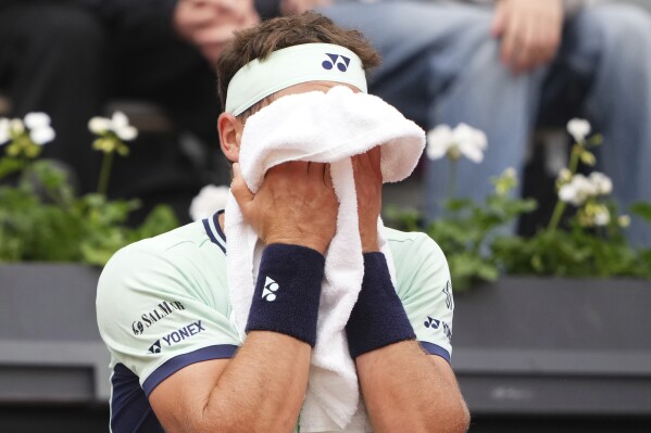 Norway's Casper Ruud wipes his face as he plays Portugal's Nuno Borges during their second round match of the French Tennis Open, at the Roland-Garros stadium, in Paris, Wednesday, May 28, 2025. (AP Photo/Lindsey Wasson)